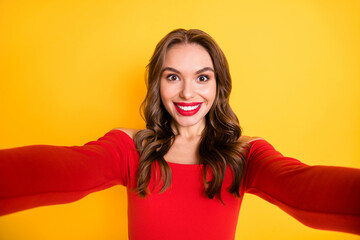 Photo portrait of girl wearing off-shoulders top smiling taking selfie isolated on bright yellow color background