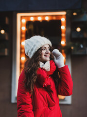 Happy long-haired girl in a warm red jacket