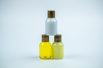 Photo of a three bottles of shampoo making a pyramide