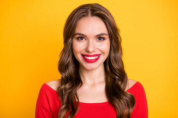 Photo portrait of female student smiling happy in red casual top isolated on vibrant yellow color background