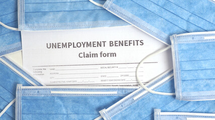 Concept Unemployment benefits claim form and face masks. Covid-19