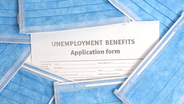 Concept Unemployment Benefits Claim Form And Face Masks. Covid-19