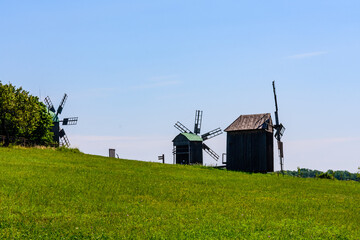 Fototapeta na wymiar Old wooden wind mill in Pyrohiv, Ukraine