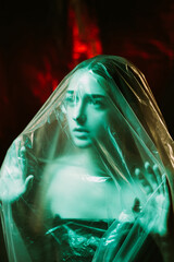 Covid-19 self isolation. Defocused portrait. Quarantine anxiety. Scared terrified woman trapped in...