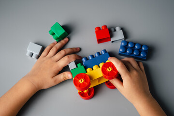 Naklejka premium The child plays a constructor. Logical buses for brain development. Early learning. Educational toys