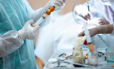 liposuction and lipofilling concept, surgery in the operating room - fat cell transplant.
