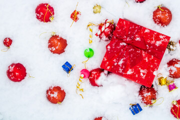 January, new year ornaments and gift box with snow, happy birthday background