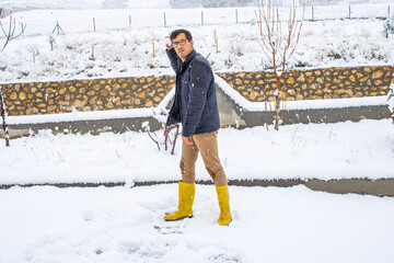 Young man playing snowballs, man throwing snowballs