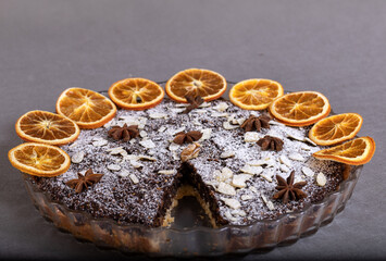 Tart with poppy seeds and fruit sprinkled with powdered sugar