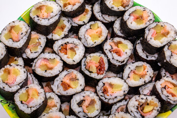 Top view of stack of Japanese sushi maki roll plate. Served in Japanese bar restaurant with chopstick