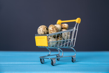 Raw quail eggs in mini shopping cart