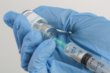 Scientist or medical worker holds Corona virus vaccine bottle.Vaccination, immunization, treatment...