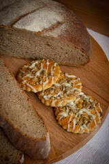 Bread and biscuits with seeds for breakfast. Slices of bread close-up. Freshly baked aromatic rye bread, cut into pieces.