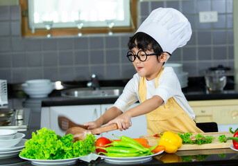 Happy Asian boy having breakfast with preparing food in the kitchen