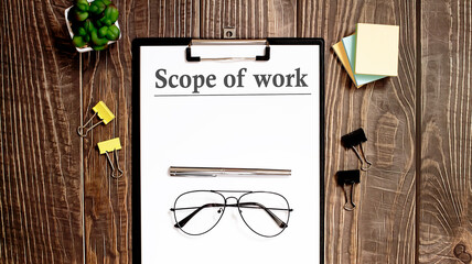 Scope of work text form on wooden table with office tips