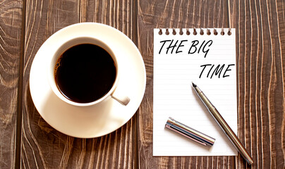 THE BIG TIME - white paper with pen and coffee on wooden background