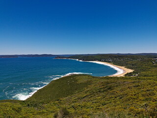 Beautiful view of a deep blue sea and sandy beach from a mountain lookout, Bullimah Lookout, Bouddi National Park, National Park, New South Wales, Australia
