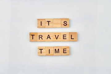 Travel time message written on wooden blocks. Vacation and travel concept on white background.