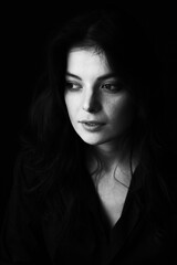 Emotional Sensual black and white portrait of a beautiful girl on a dark background