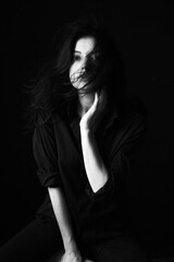 Naklejka premium Emotional Sensual black and white portrait of a beautiful girl on a dark background