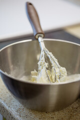 Whipped buttercream in a metal bowl. Homemade baking.
