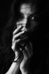 Emotional Sensual black and white portrait of a beautiful girl on a dark background