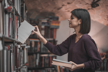 Portrait of beautiful woman bookshop owner. Successful independent businesswoman, owner of a book...