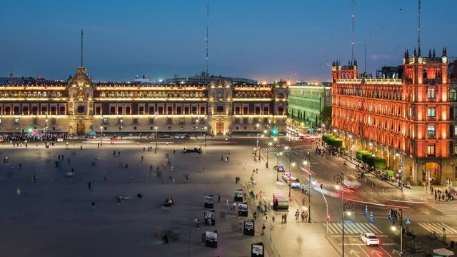 Day to night time lapse view of people and traffic around historical landmarks Zocalo Square (Spanish: Plaza del Zocalo ) and National Palace in the Historic Center of Mexico City, Mexico. 
