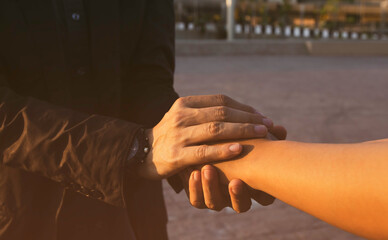 Obraz premium Businessman with client holding hands together for comfort and support work together, which help as insurance team,Respect and trust promise concept