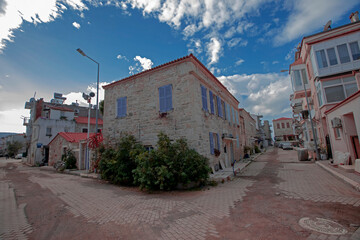 Fototapeta na wymiar Turkey's Izmir - Former foça district of colored stone houses famous windowed view. Former foça Turkey is a popular historic tourist center.
