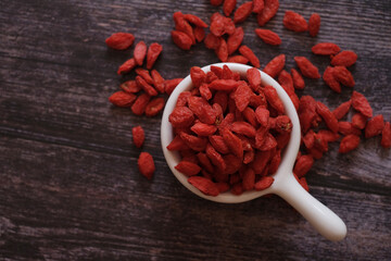 Dried Chinese wolfberries or Goji berry chinese herb or Matrimony vine in the white ceramic bowl...