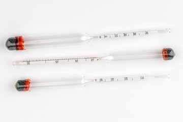 device for measuring the degree of alcohol in a distillery on a white background