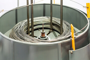 Material roll stainless wire or steel in rotation round tank for feed to continuous automatic...