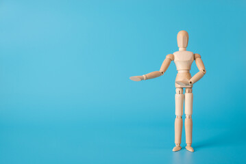 Welcome back concept. Photo of wooden male figure showing hands to the side isolated blue backdrop with copy space