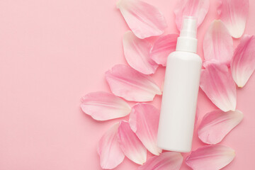 Flat lay overhead close up view photo image of white for mock up sprayer lying on pastel color petals