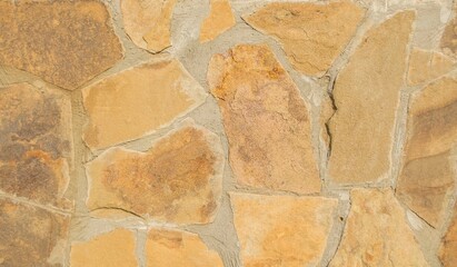 Wall of large brown stones natural background