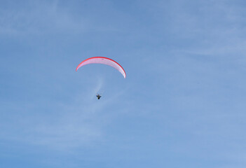 Paraglider flying over the mountains in winter