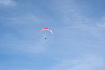 Paraglider flying over the mountains in winter