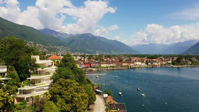 Aerial drone footage of the typical Ascona village with a revealing move closed to luxury mansion by lake Maggiore in Canton Ticino is Switzerland.