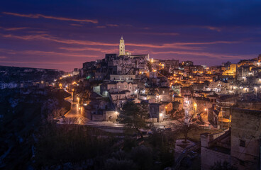 Fototapeta premium Matera, Basilicata, Italy at night. The old town (sassi di Matera), European Capital of Culture. Church San Pietro Barisano and duomo cathedral. Unesco World Heritage site.