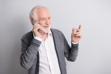 Photo of old optimistic man talk by telephone wear dark sweater isolated on grey background