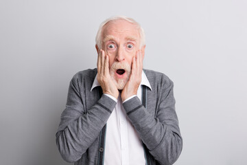 Portrait of old white hair impressed man hands face open mouth wear dark sweater isolated on grey background