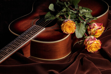 Still life with a guitar and a bouquet of roses.