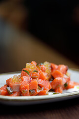 Salmon tartare on a white plate. Gourmet Food, salmon chopped close-up.