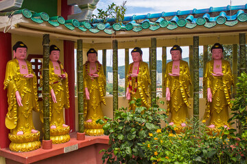 The gallery of the Buddha statues on the territory of Kek Lok Si Buddhist temple, Penang island, Malaysia
