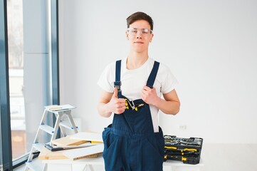 Hilarious busy constructor repairing apartment