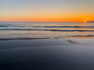 Beautiful orange sunset at the sand beach