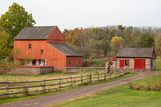 Red barn and log cabin at historic Daniel Boone Homestead. No release required, government property permits commercial photography.