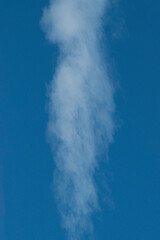 The structure of the smoke from the chimney against the blue sky. Space for text, copy space, space for printing.