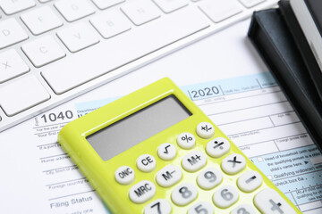Calculator, notebooks and document on table, closeup. Tax accounting